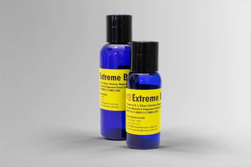 two bottles of extreme brown 100% natural pain relief ointment, blue bottle with yellow label